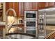 Kitchen with double sink, granite counters, tile backsplash, stainless appliances and custom cabinets at 919 Woodham, Pittsboro, NC 27312
