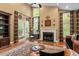 Spacious living room with hardwood floors, fireplace, ceiling fan, and many windows bringing in natural light at 919 Woodham, Pittsboro, NC 27312