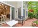 Exterior patio with red brick, outdoor furniture and view into the dining room at 919 Woodham, Pittsboro, NC 27312