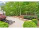 Beautiful patio with lounging chairs, stone retaining wall, and landscaping at 919 Woodham, Pittsboro, NC 27312