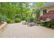 Beautiful patio with lounging chairs, stone retaining wall, and landscaping at 919 Woodham, Pittsboro, NC 27312