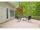 A brick patio features an outdoor seating area with a table and four chairs at 919 Woodham, Pittsboro, NC 27312