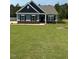 Charming single-story home with blue siding, black shutters, and a well-manicured lawn at 95 Knoll Way, Sanford, NC 27332