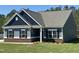 Charming single-story home featuring a blue exterior, brick foundation, well-manicured lawn, and classic architectural details at 95 Knoll Way, Sanford, NC 27332