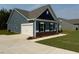 View of blue home with a two-car garage and concrete driveway at 95 Knoll Way, Sanford, NC 27332