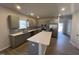 Well-equipped kitchen with quartz countertops, stainless steel appliances, gray cabinets, and an island with sink at 95 Knoll Way, Sanford, NC 27332