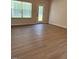 Bright living room featuring wood-look flooring and a view of the backyard at 95 Knoll Way, Sanford, NC 27332