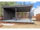 Relaxing outdoor covered back porch with modern furniture and stylish decor at 956 The Parks Dr, Pittsboro, NC 27312