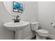 Clean, well-maintained bathroom with pedestal sink and toilet at 956 The Parks Dr, Pittsboro, NC 27312