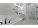 Spa-like bathroom with a soaking tub, dual vanities, and a glass-enclosed shower at 956 The Parks Dr, Pittsboro, NC 27312