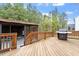 Deck with wooden railings, featuring a grill and a view of the backyard at 956 The Parks Dr, Pittsboro, NC 27312