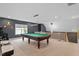 Bright game room with a pool table, neutral carpet and modern lighting at 956 The Parks Dr, Pittsboro, NC 27312