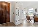 Bright home office with hardwood floors, a modern desk, executive chairs, and a unique wooden door at 956 The Parks Dr, Pittsboro, NC 27312