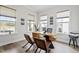Bright office features hardwood floors, three large windows, a modern desk, and industrial-style chairs at 956 The Parks Dr, Pittsboro, NC 27312