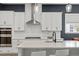 Modern kitchen with white cabinetry, subway tile backsplash, stainless steel appliances, and a large island at 956 The Parks Dr, Pittsboro, NC 27312