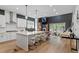 Open concept kitchen with a large island, quartz countertop, pendant lighting, and stainless steel appliances at 956 The Parks Dr, Pittsboro, NC 27312