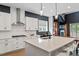 Modern kitchen with white cabinets, stainless steel appliances, and a large quartz island at 956 The Parks Dr, Pittsboro, NC 27312