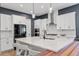 Bright kitchen with white cabinets, a large island with quartz countertops, and stainless steel appliances at 956 The Parks Dr, Pittsboro, NC 27312