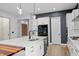 Modern kitchen with quartz island countertop, stainless steel appliances, and a clean, minimalist design at 956 The Parks Dr, Pittsboro, NC 27312