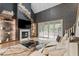 Open-concept living room featuring modern fireplace, decorative wall accents, and access to the outdoors at 956 The Parks Dr, Pittsboro, NC 27312