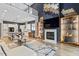 Spacious living room flowing into a modern kitchen, with sleek fireplace and stylish decor at 956 The Parks Dr, Pittsboro, NC 27312