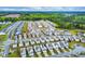 An aerial view of a neighborhood shows neat rows of modern homes, lush greenery, and well-maintained streets and sidewalks at 1018 Sweet Cream Ct, Durham, NC 27703