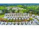 An aerial view shows a well-maintained neighborhood with beautiful landscaping and numerous trees surrounding the homes at 1018 Sweet Cream Ct, Durham, NC 27703