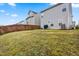 Expansive, grassy backyard with privacy fence and a view of the neighboring houses at 1018 Sweet Cream Ct, Durham, NC 27703