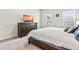 Cozy bedroom featuring a wooden dresser with TV, plush bedding, and ample natural light from two bright windows at 1018 Sweet Cream Ct, Durham, NC 27703