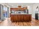 Spacious kitchen featuring dark wood cabinets, a large island, and stainless steel appliances at 1018 Sweet Cream Ct, Durham, NC 27703