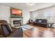 Spacious living room with a cozy fireplace, modern decor, and comfortable seating at 1018 Sweet Cream Ct, Durham, NC 27703