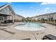 The neighborhood pool features a zero entry area and is surrounded by lounge chairs and tables with seating at 1018 Sweet Cream Ct, Durham, NC 27703