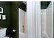 Bathroom with a shower featuring white shower walls and dark green painted walls at 102 Windrock Lane, Cary, NC 27518