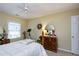 Bedroom features a ceiling fan, wood dresser, and exercise machine next to a window at 102 Windrock Lane, Cary, NC 27518