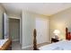 Bedroom featuring a wood bedframe, closet with sliding doors, and an adjacent room at 102 Windrock Lane, Cary, NC 27518