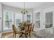 Cozy breakfast nook featuring a chandelier and a table set for four at 102 Windrock Lane, Cary, NC 27518