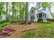 Back exterior showcasing deck, lush trees, and privacy at 102 Windrock Lane, Cary, NC 27518