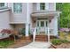 Inviting front porch with elegant details and landscaped garden at 102 Windrock Lane, Cary, NC 27518