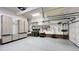 Spacious garage with epoxy flooring and ample storage with wall storage units and shelves at 102 Windrock Lane, Cary, NC 27518