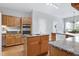 Well-equipped kitchen featuring oak cabinets, granite countertops, and modern appliances for easy meal preparation at 102 Windrock Lane, Cary, NC 27518