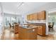 Bright kitchen area with dual islands, oak cabinetry, and a cozy breakfast nook with large windows at 102 Windrock Lane, Cary, NC 27518
