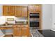 This kitchen area features stainless appliances, granite counters, and wood cabinetry at 102 Windrock Lane, Cary, NC 27518