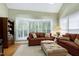 Comfortable living room with large windows, providing ample natural light and a view of the outdoors at 102 Windrock Lane, Cary, NC 27518