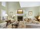 Comfortable living room featuring a fireplace and classic decor at 102 Windrock Lane, Cary, NC 27518