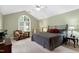 Vaulted ceiling main bedroom featuring cozy seating area and large window at 102 Windrock Lane, Cary, NC 27518