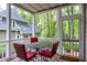 Comfortable screened-in porch with seating area, perfect for relaxing outdoors at 102 Windrock Lane, Cary, NC 27518