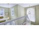 Bright stairway featuring white railings, olive walls, pendant lighting and natural light at 102 Windrock Lane, Cary, NC 27518