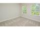 Neutral bedroom features carpeted floors, and several double hung windows at 1020 Kentlands Dr, Durham, NC 27713