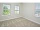 Carpeted bedroom features three double hung windows at 1020 Kentlands Dr, Durham, NC 27713