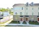 Beautiful three-story townhome featuring a brick and siding exterior with large windows at 1020 Kentlands Dr, Durham, NC 27713